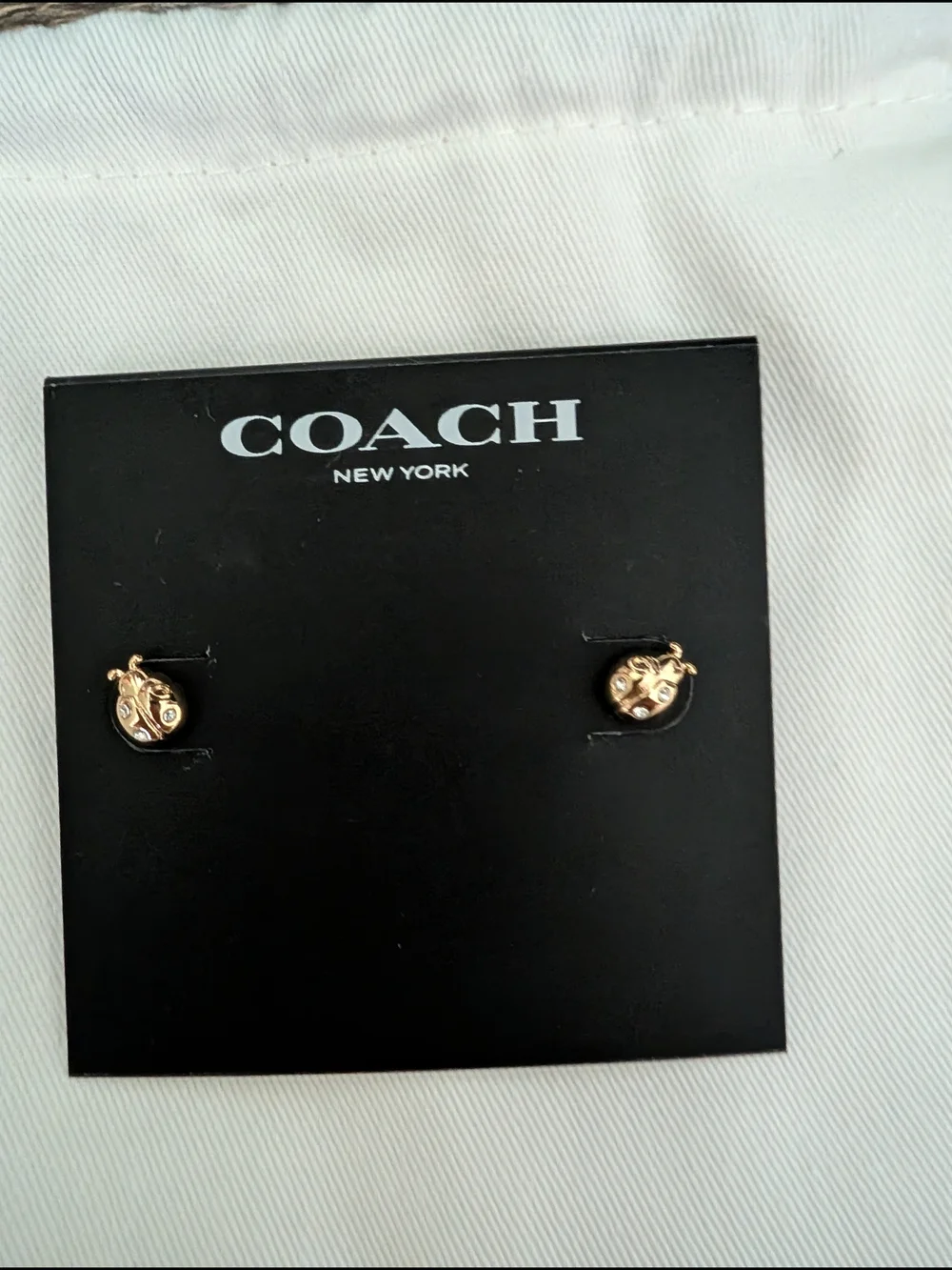 Coach Gold Tone Ladybug Stud Earrings with Crystal Accents